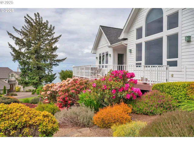 a front view of a house with a yard and a garden