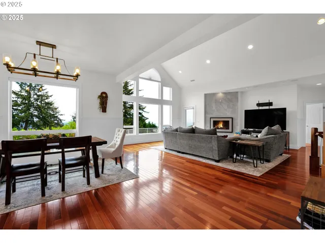 a living room with furniture a flat screen tv and a table