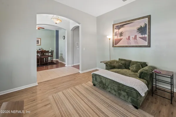 a living room with furniture and wooden floor