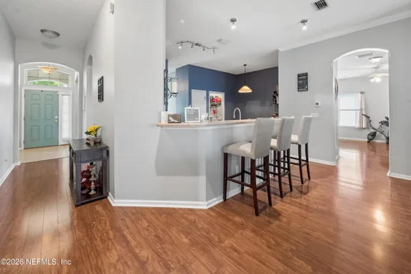 a view of a dining room with furniture and wooden floor