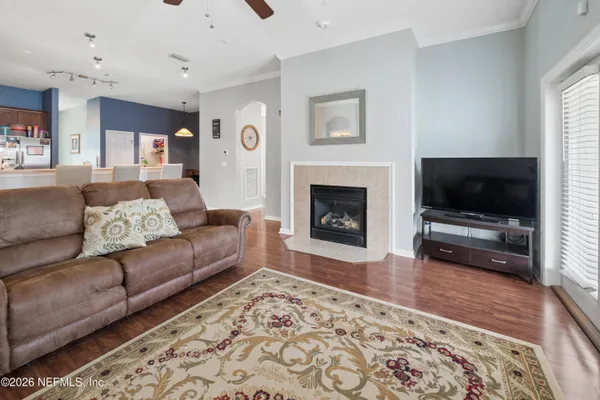 a living room with furniture a flat screen tv and a fireplace
