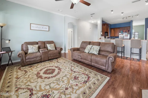 a living room with furniture and a wooden floor