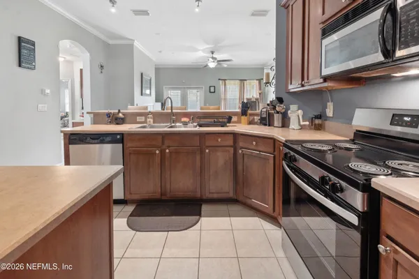 a kitchen with a sink cabinets and stainless steel appliances