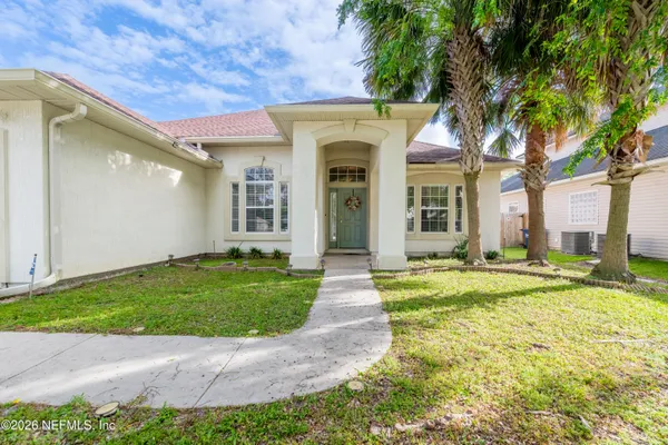 a view of a house with a backyard