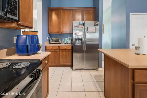 a kitchen with stainless steel appliances granite countertop a stove a refrigerator and a sink