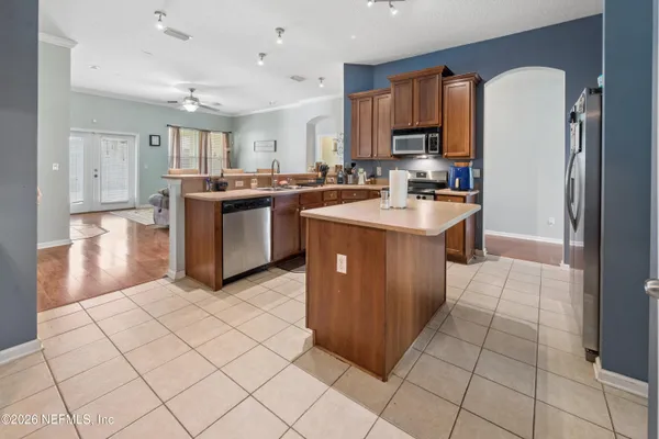 a kitchen with stainless steel appliances granite countertop a refrigerator and a stove top oven
