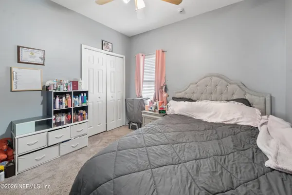 a bedroom with a bed and a book shelf