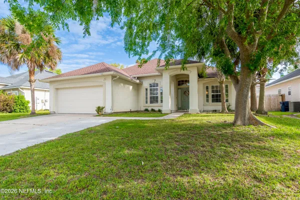a front view of house with yard and green space