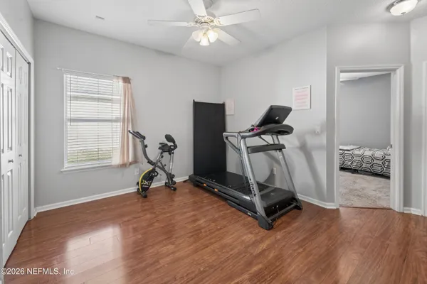 a room with gym equipment and windows