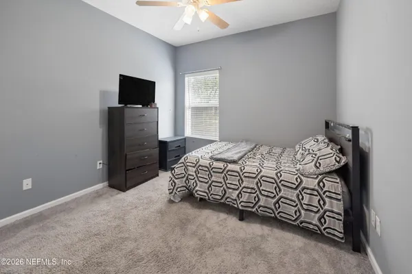 a bedroom with a bed and a television