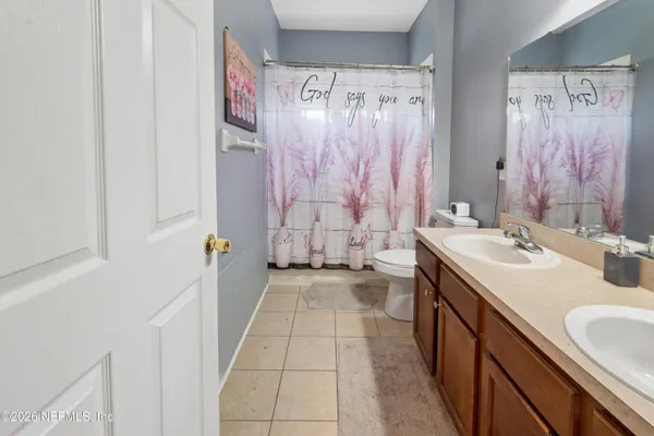 a bathroom with a sink a mirror and a shower