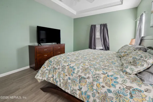 a bedroom with a bed and a flat screen tv