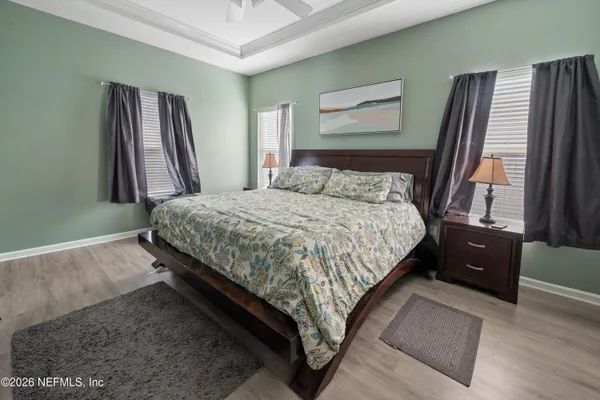 a bed sitting in a bedroom next to a window