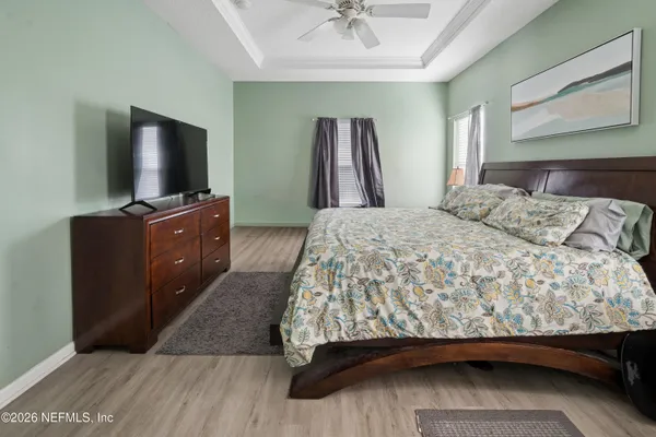 a bedroom with a bed and a flat screen tv