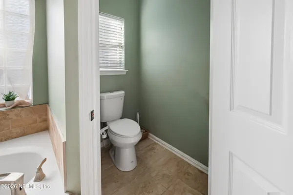 a white toilet sitting next to a bathroom sink
