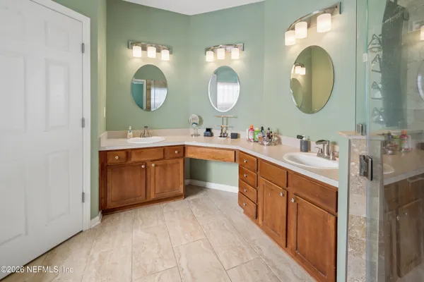 a spacious bathroom with a double vanity sink double and a mirror