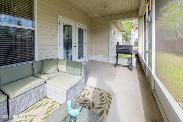 a balcony with furniture and a potted plant