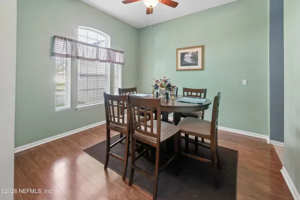 a view of a dining room with furniture window and wooden floor