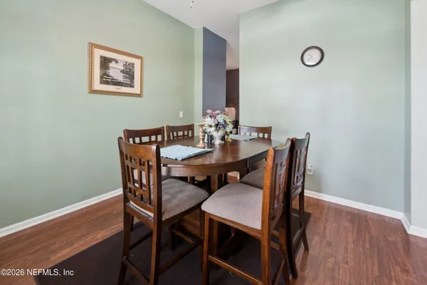 a view of a dining room with furniture and wooden floor