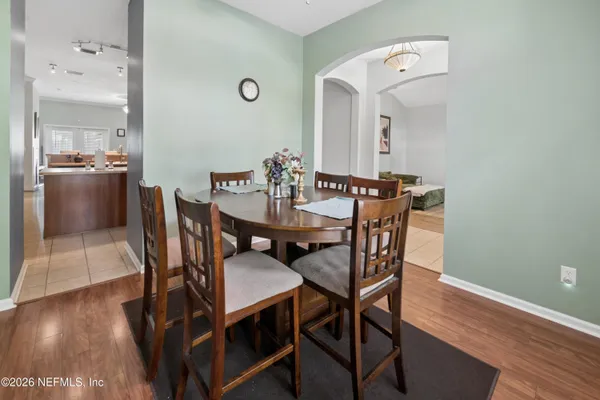 a view of a dining room with furniture and wooden floor