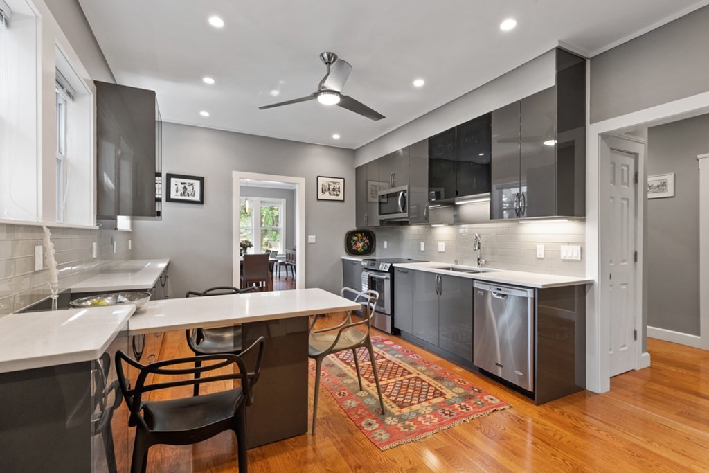 102 Addington Road, Unit 2 Brookline, MA 02445 - Photo 17 of 30 a kitchen with a stove a sink and a refrigerator