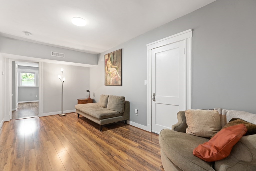 102 Addington Road, Unit 2 Brookline, MA 02445 - Photo 24 of 30 a living room with furniture and a wooden floor