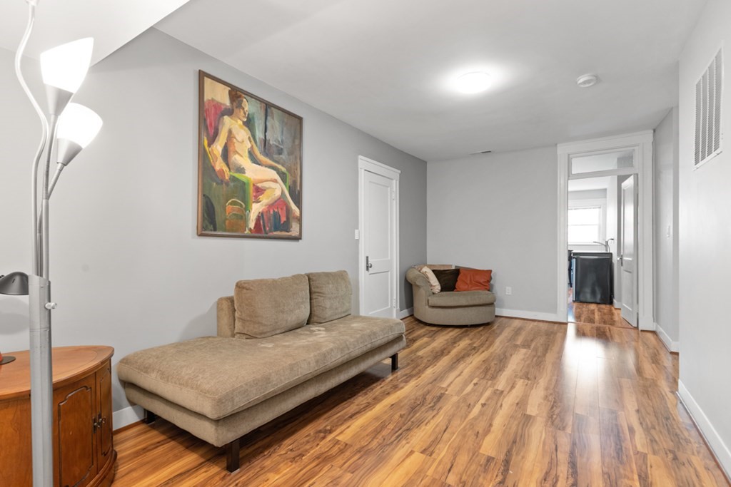 102 Addington Road, Unit 2 Brookline, MA 02445 - Photo 25 of 30 a living room with furniture and wooden floor