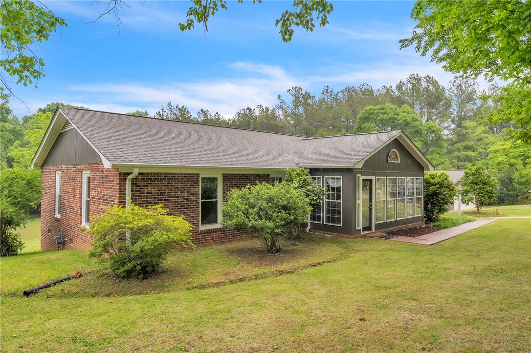 722 Lay Bridge Road Central, SC 29630 - Photo 2 of 32 This home features a blend of brick and siding, with a well-maintained lawn.