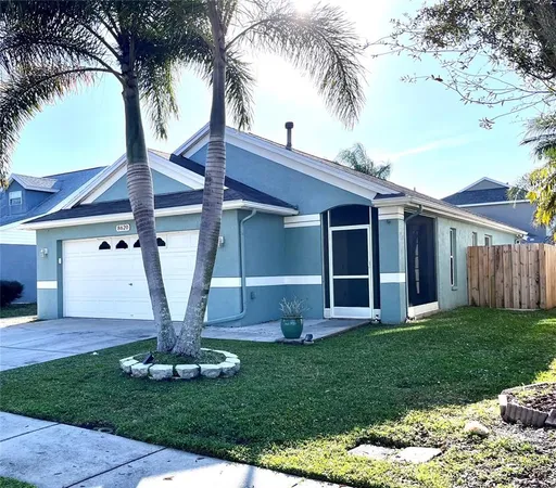 a view of a house with a backyard