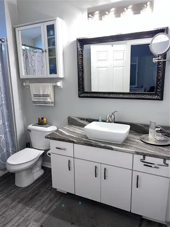 a front view of a house with a garden and trees