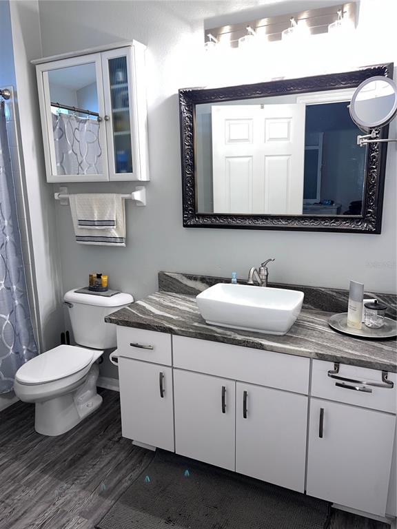 8620 Persea Court New Port Richey, FL 34655 - Photo 11 of 14 a bathroom with a toilet sink and mirror