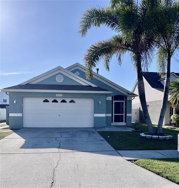 8620 Persea Court New Port Richey, FL 34655 - Photo 13 of 14 a front view of a house with garden