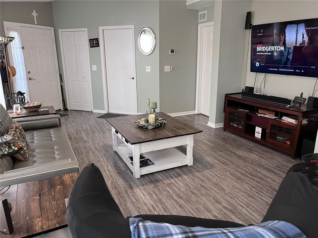 8620 Persea Court New Port Richey, FL 34655 - Photo 2 of 14 a living room with furniture and a flat screen tv