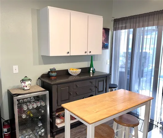a spacious bedroom with a bed and a chandelier