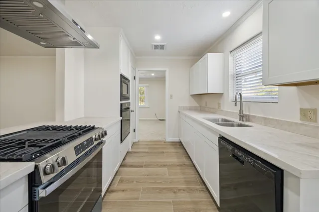 a kitchen with a sink stove and cabinets