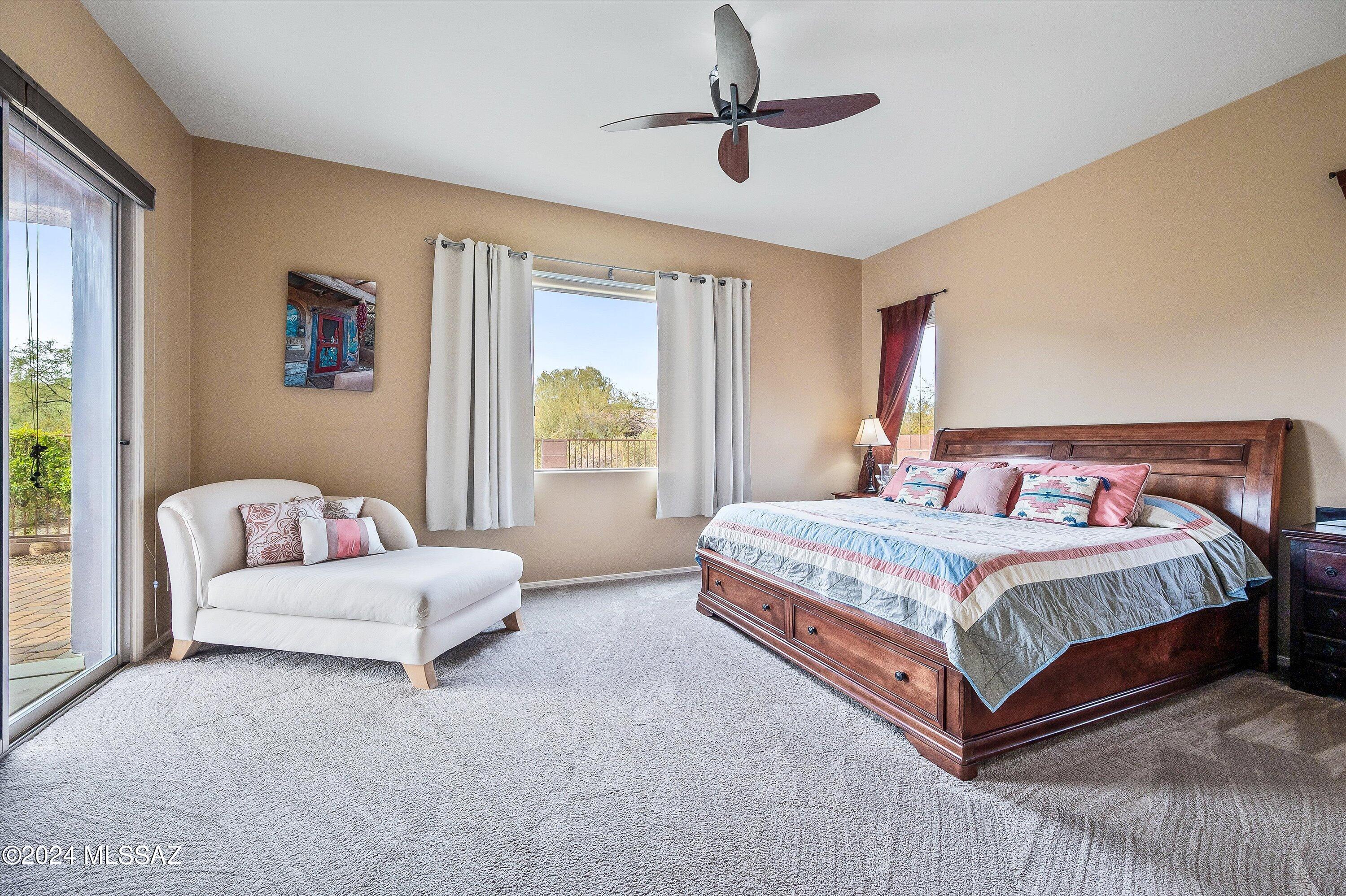 8579 North Shadow Wash Way Tucson, AZ 85743 - Photo 21 of 34 a bedroom with a bed couch and window