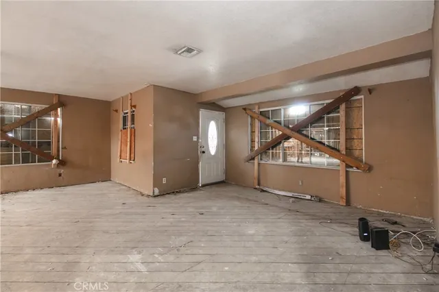 a view of an empty room and wooden floor