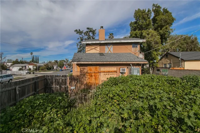 a aerial view of a house with a yard and potted plants