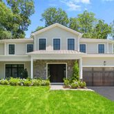a front view of a house with a garden and yard
