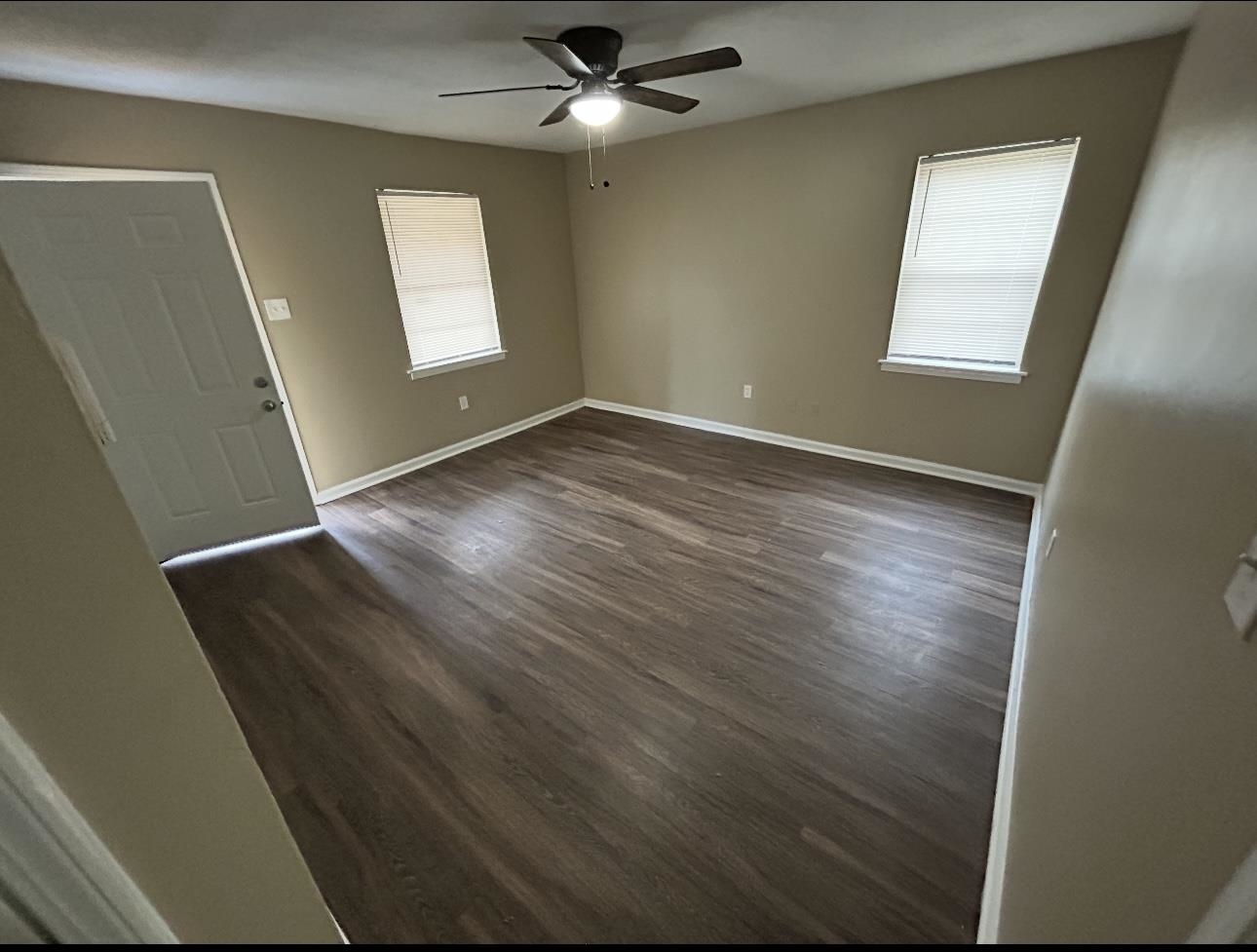 3396 Outlet Road Memphis, TN 38109 - Photo 6 of 6 an empty room with wooden floor and windows