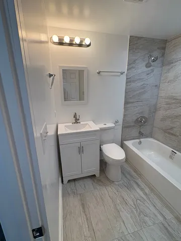 a bathroom with a toilet a sink and a bathtub