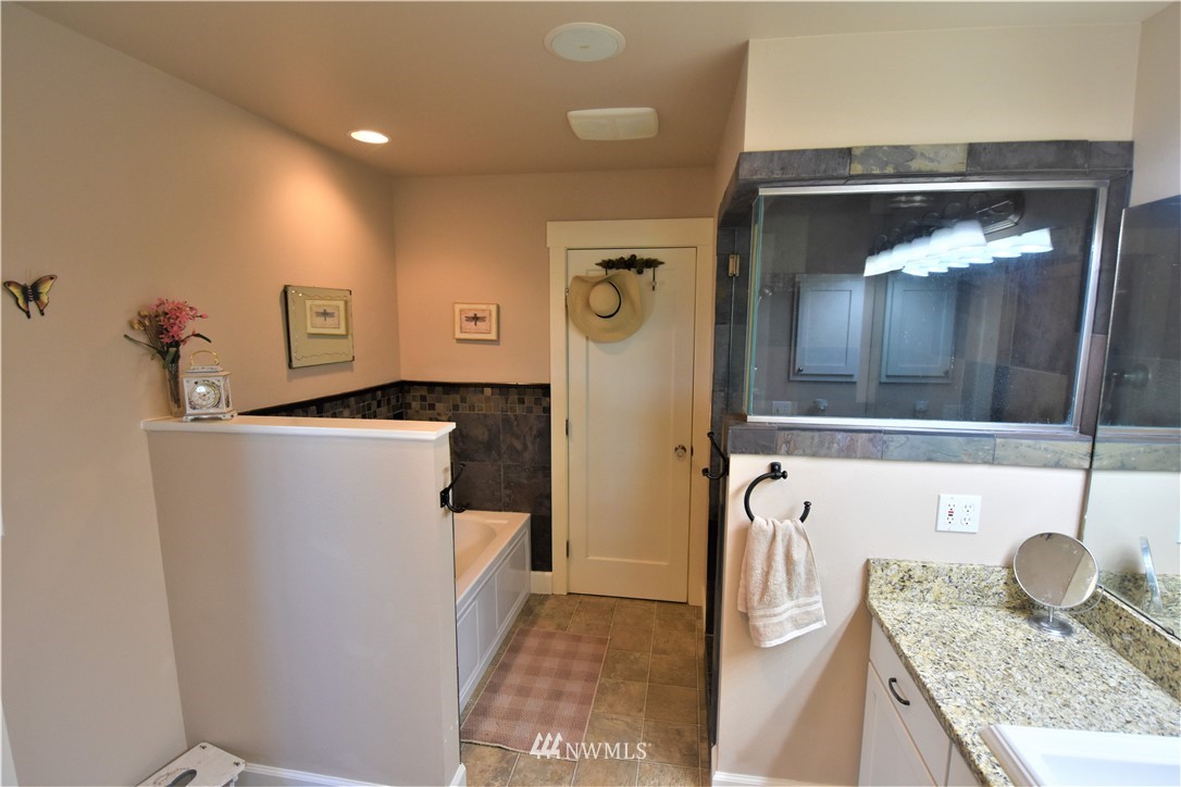415 Bowers Road Yakima, WA 98908 - Photo 11 of 25 a bathroom with a granite countertop sink and a mirror