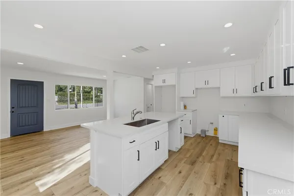 a kitchen with a sink stove and cabinets