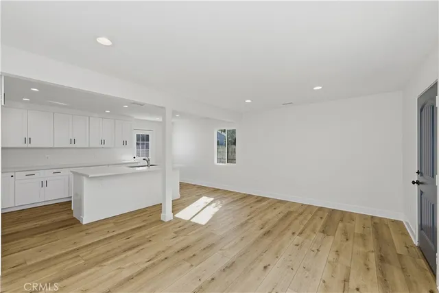a view of a kitchen with wooden floor
