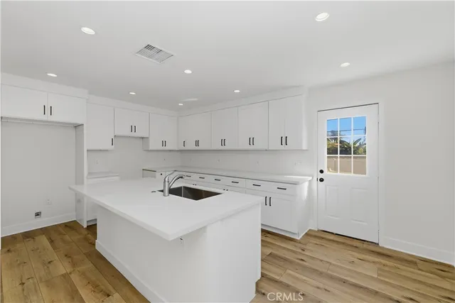 a kitchen that has a sink a stove and a microwave