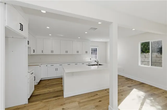a kitchen with a sink window and cabinets