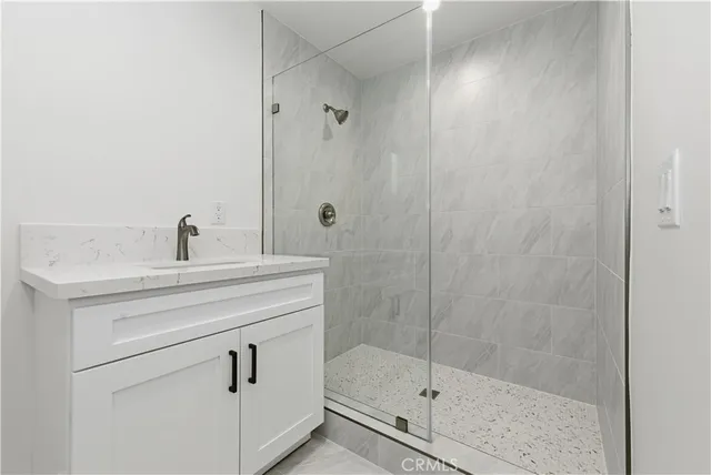 a bathroom with a shower sink and mirror