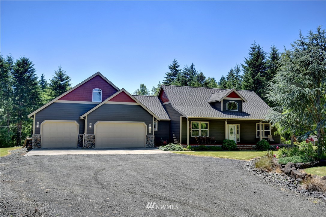 15837 Case Road Southwest Rochester, WA 98579 - Photo 1 of 40 a front view of a house with a yard and garage