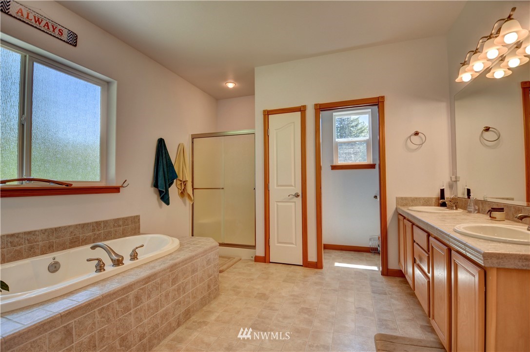 15837 Case Road Southwest Rochester, WA 98579 - Photo 14 of 40 a bathroom with a tub sink and mirror