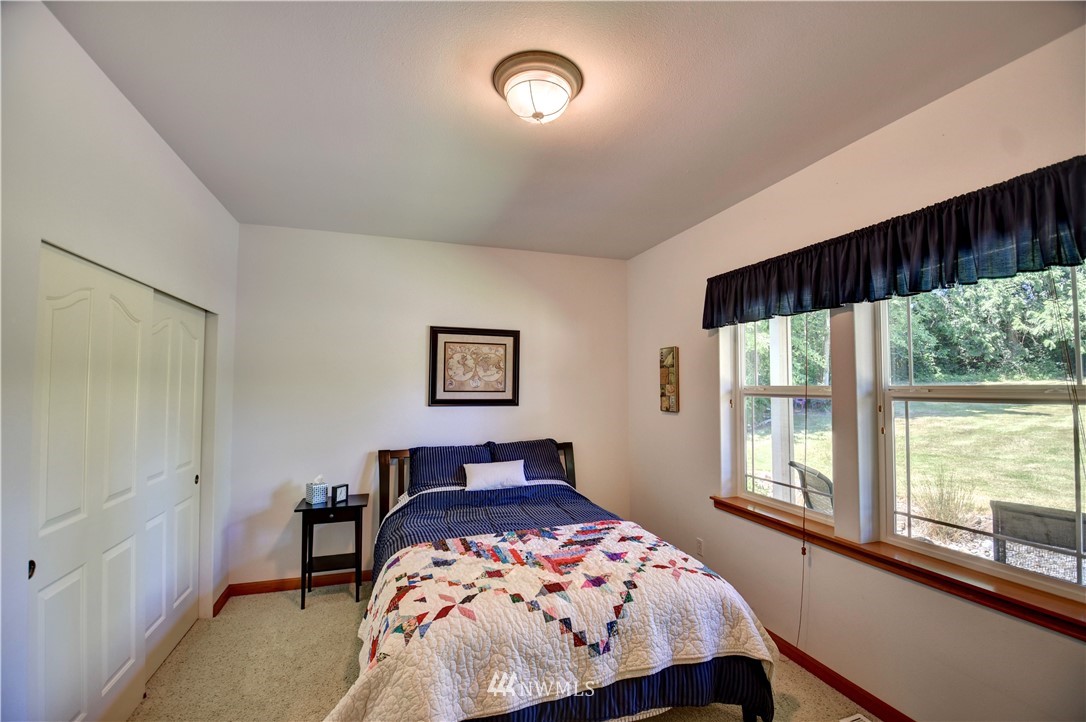 15837 Case Road Southwest Rochester, WA 98579 - Photo 16 of 40 a bedroom with a bed and a large window